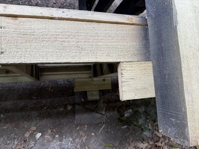 Back of the log store showing how the flooring is now being supported with an extra offcut of wood.