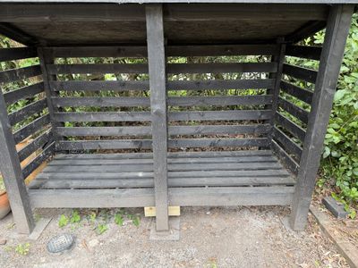 Empty log store showing the flooring fix at the middle front post unpainted.