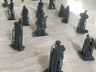 The 3D printed figures drying off with supports still attached.