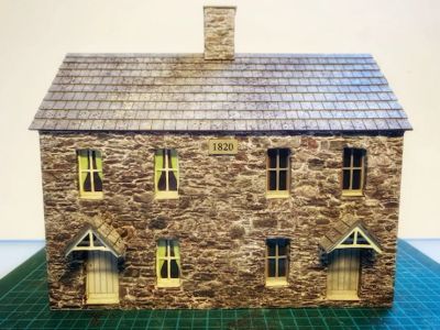 Roof and chimney stack completed. Glazing, curtains added and window frames painted. Porches and date stone added.