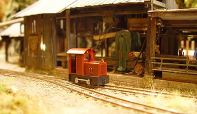 Japanese L Type industrial locomotive outside a woodshed