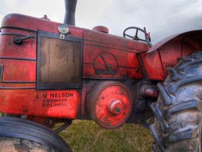 Side View of red L V Nelson tractor.