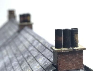 Chimneys on the roof of the cottages.